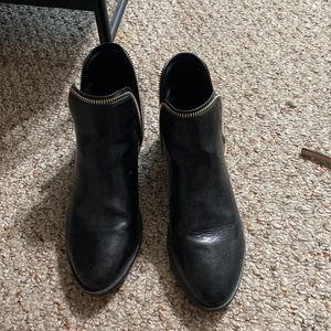 Black booties with gold zipper